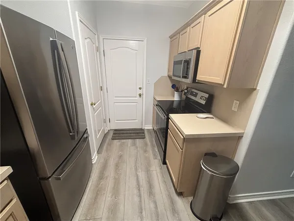 a kitchen with a sink a refrigerator and washer