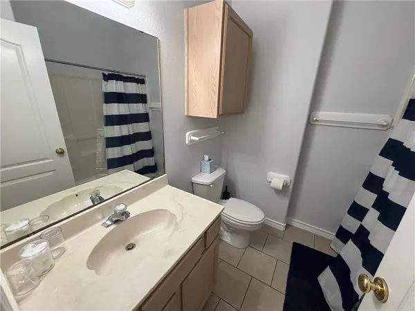 a bathroom with a sink and mirror with toilet
