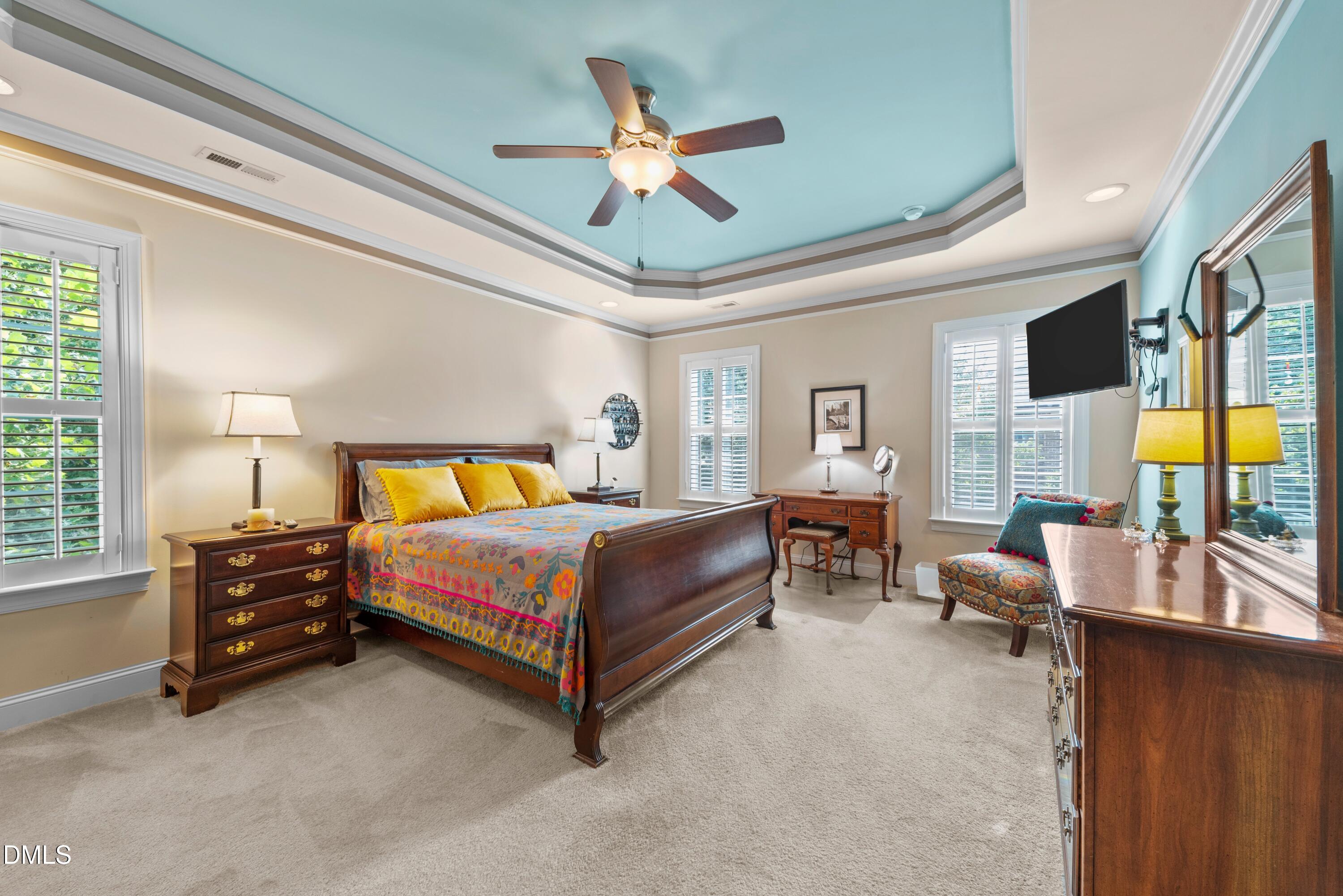 671 Whisper Ridge Drive Graham, NC 27253 - Photo 12 of 41 a bedroom with a bed and a chandelier