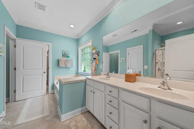 a spacious bathroom with a double vanity sink mirror and