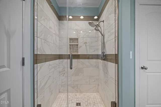 a bathroom with a glass shower door