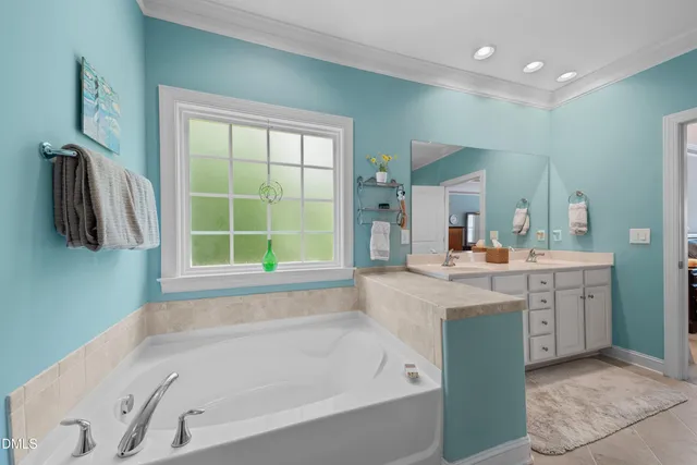 a bathroom with a tub sink and a window