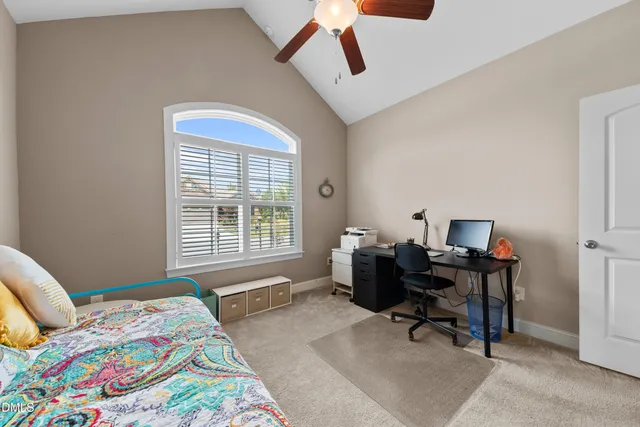 a bedroom that has a bed and a chair in it