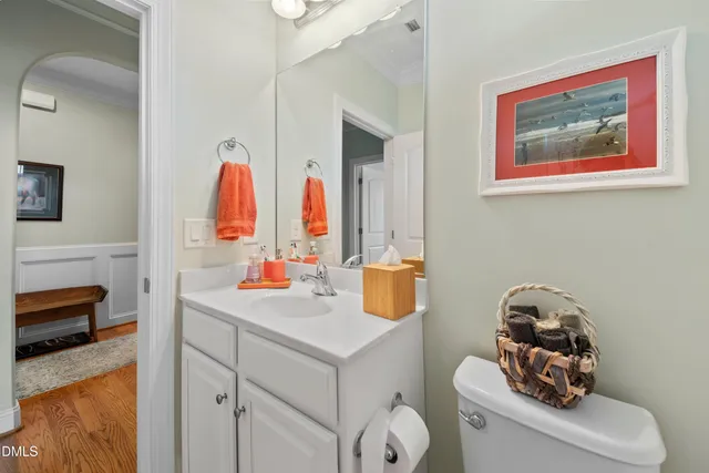 a bathroom with a sink vanity mirror and toilet