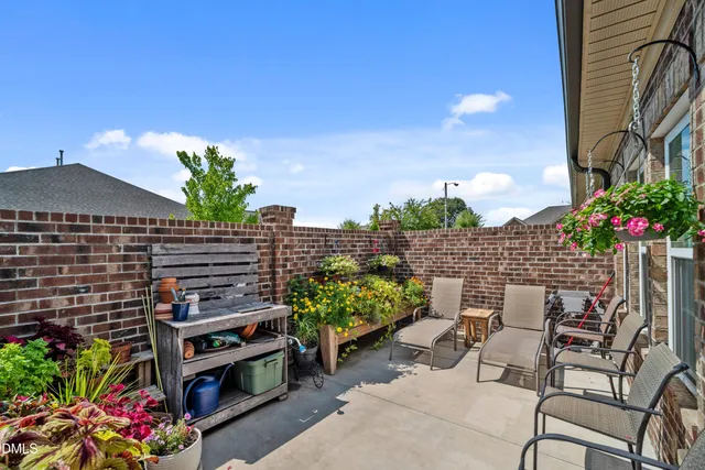 a backyard of a house with lots of green space and outdoor seating