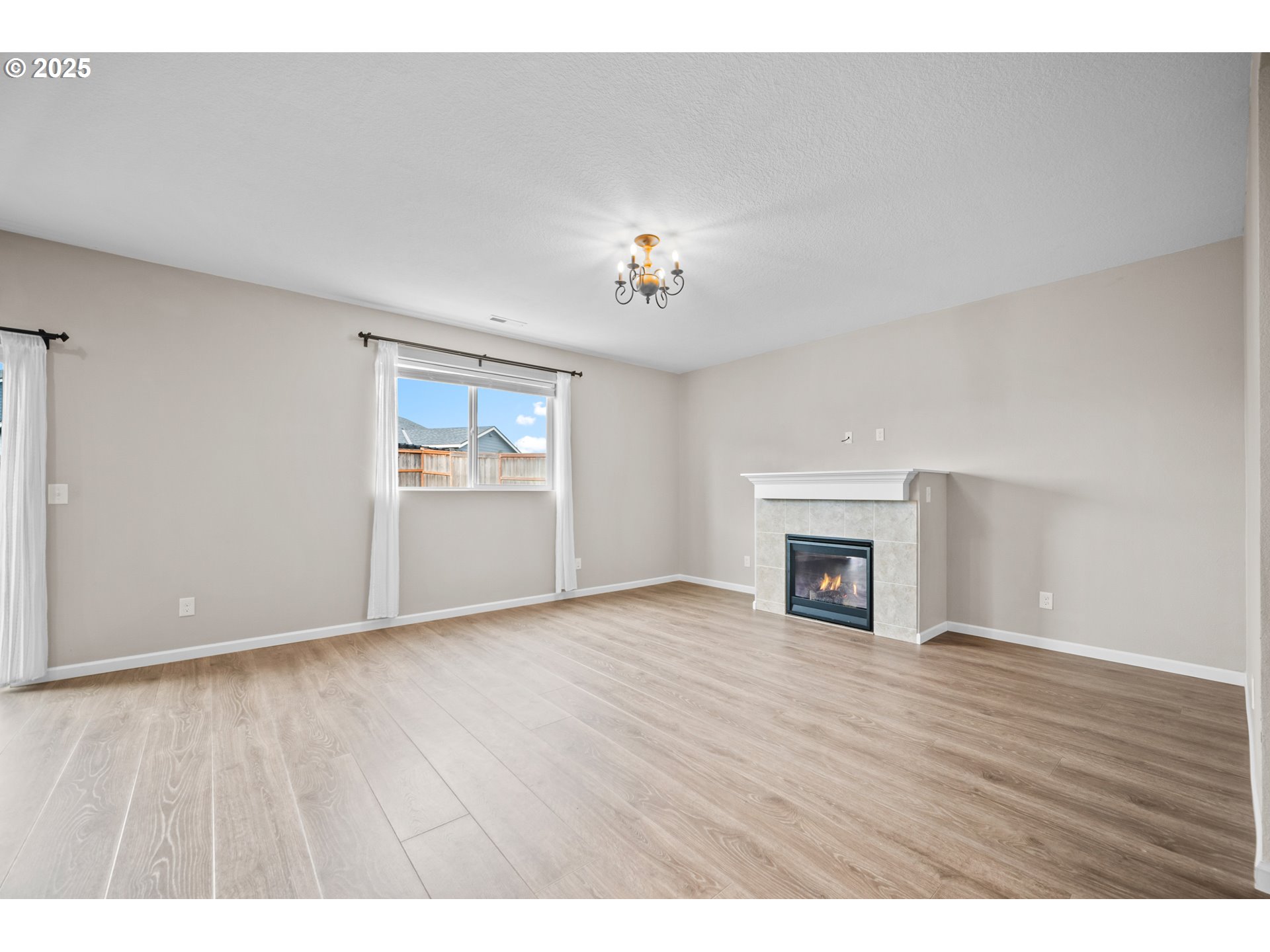 2777 South Red Tail Loop Ridgefield, WA 98642 - Photo 10 of 37 a view of empty room with wooden floor and fireplace