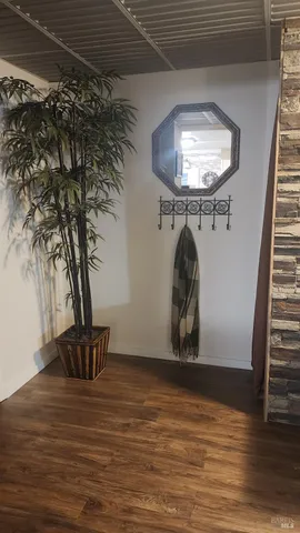 an empty room with wooden floor and closet