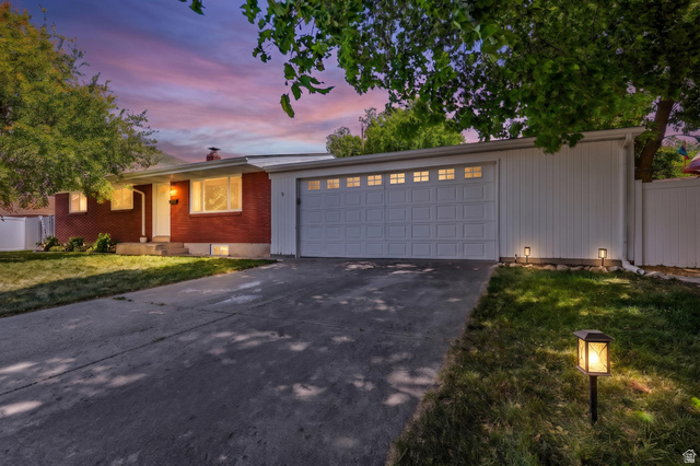 480 North 150 E Street Springville, UT 84663 - Photo 1 of 36 Red brick exterior with white trim, featuring a two-car garage with windowed doors