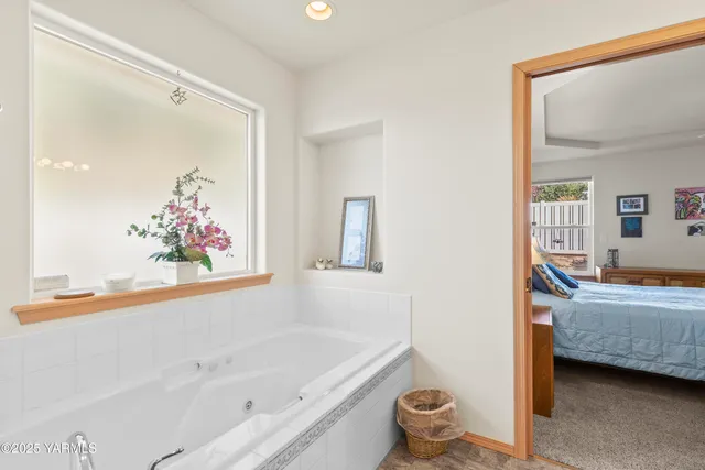 a bathroom with a tub sink and mirror