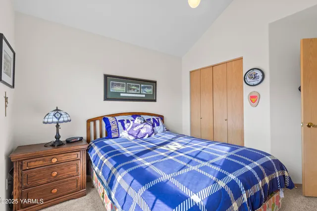 a bedroom with a bed and a dresser