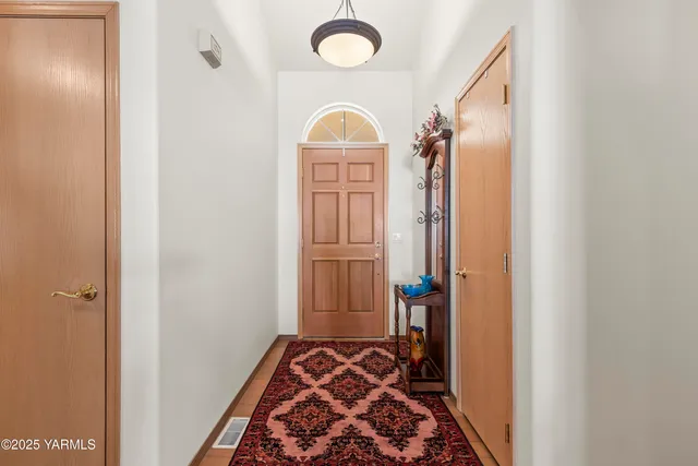 a view of front door with wooden floor