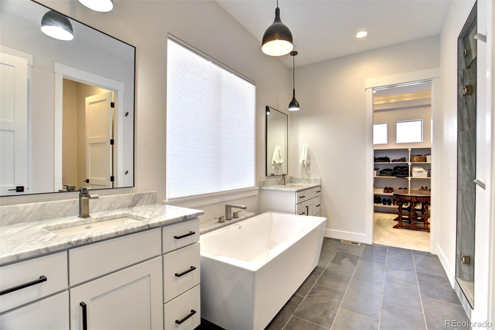 1287 Kelso Place Colorado Springs, CO 80921 - Photo 19 of 50 a bathroom with a sink double vanity and a mirror