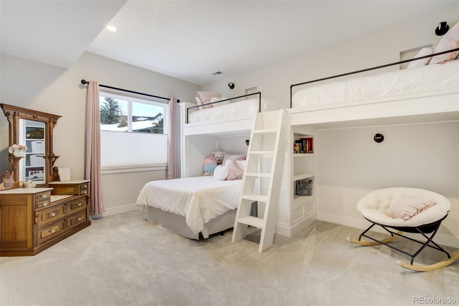 1287 Kelso Place Colorado Springs, CO 80921 - Photo 29 of 50 a bedroom with a bed and a cabinets