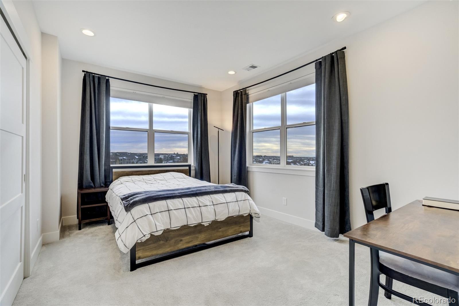 1287 Kelso Place Colorado Springs, CO 80921 - Photo 31 of 50 a spacious bedroom with a large bed and a desk