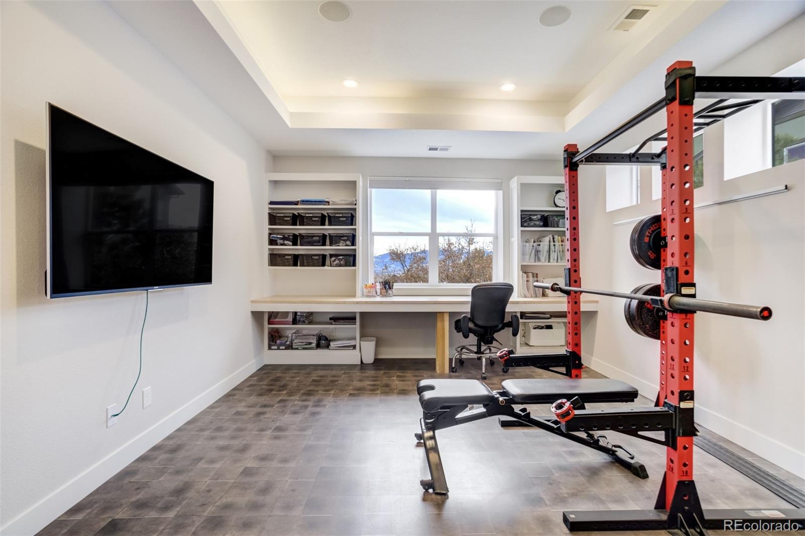 1287 Kelso Place Colorado Springs, CO 80921 - Photo 35 of 50 a view of a workspace with furniture and a flat screen tv