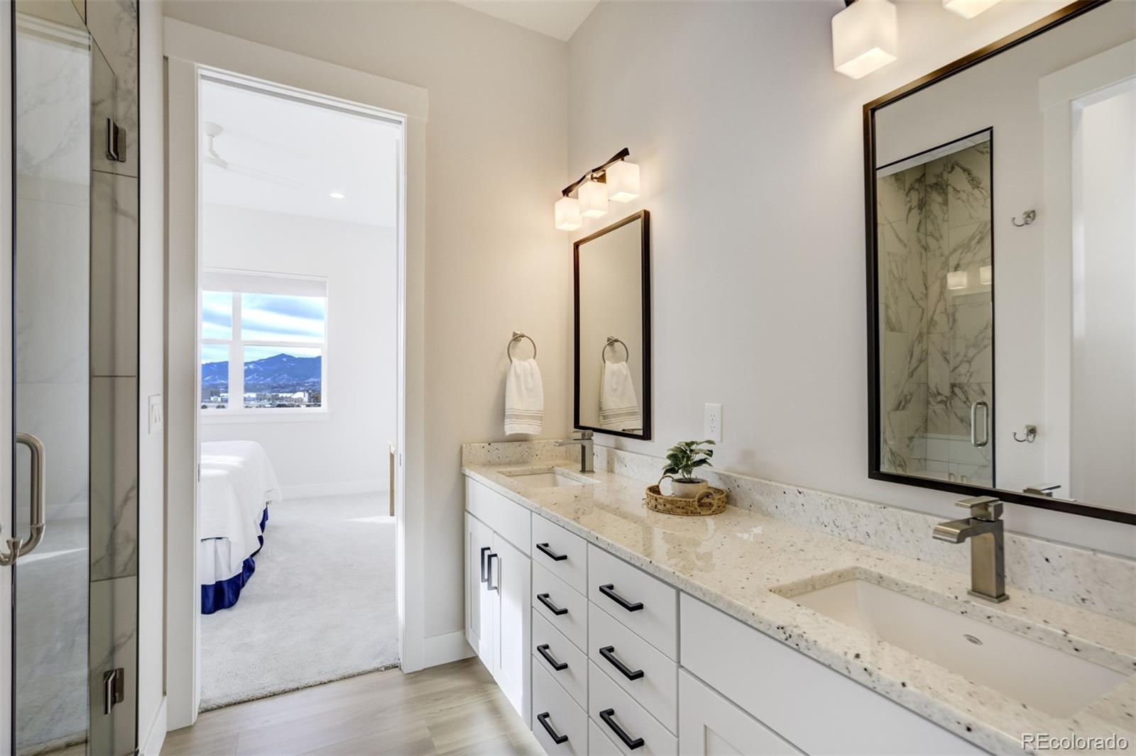 1287 Kelso Place Colorado Springs, CO 80921 - Photo 41 of 50 a bathroom with a granite countertop sink and a mirror