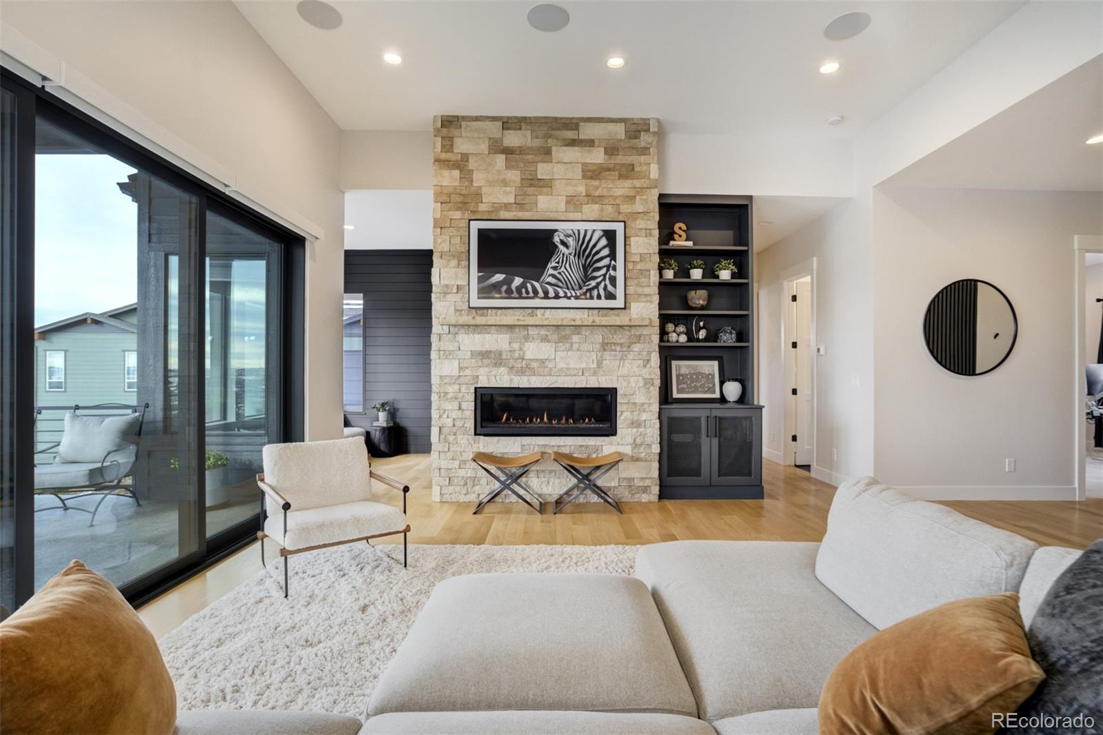 1287 Kelso Place Colorado Springs, CO 80921 - Photo 5 of 50 a living room with furniture a fireplace and a large window