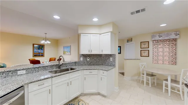 a kitchen with granite countertop a sink and cabinets