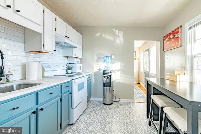 a kitchen with cabinets and window