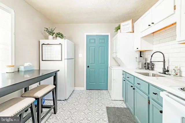 a kitchen with a sink cabinets and appliances