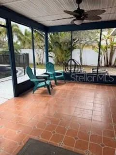 a living room with patio furniture and a floor to ceiling window