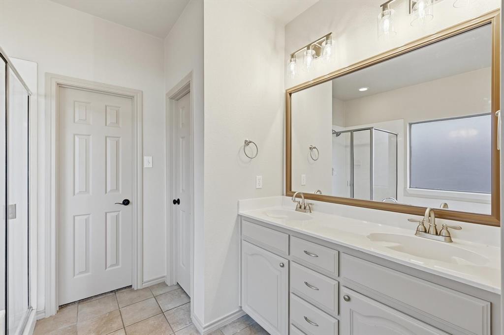 3228 Buckthorn Lane Argyle, TX 76226 - Photo 16 of 21 a bathroom with double sink and a mirror