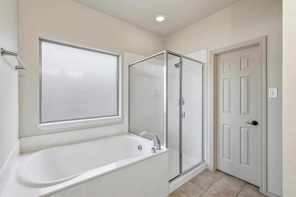 3228 Buckthorn Lane Argyle, TX 76226 - Photo 17 of 21 a bathroom with a bathtub and a shower