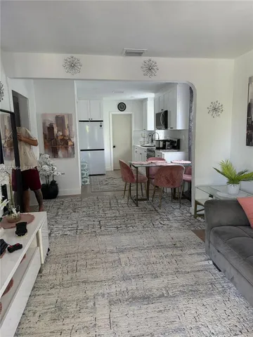 a living room with furniture and a rug