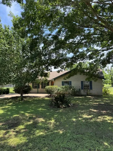 a backyard of a house with yard and outdoor seating