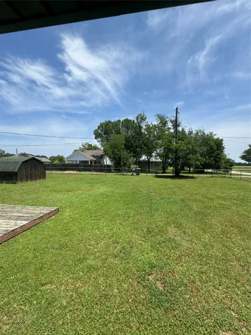 a view of a garden with a building in the background