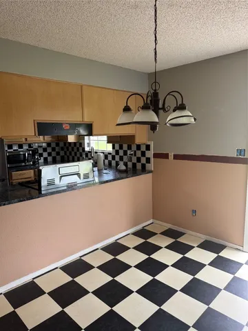 a room with lots of appliances and cabinets