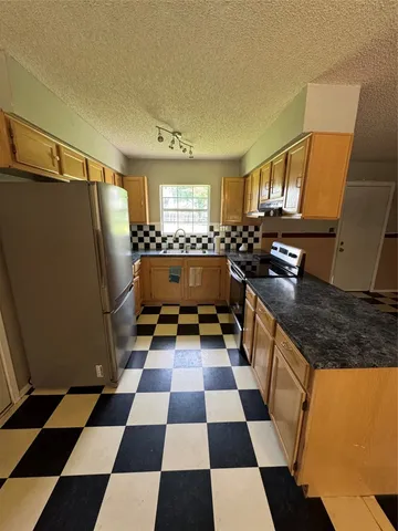 a kitchen with a checkered floor and a black white checkered floor