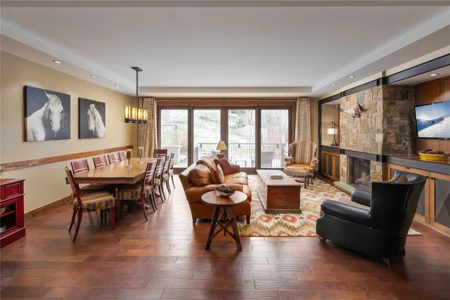 a living room with fireplace furniture and a large window