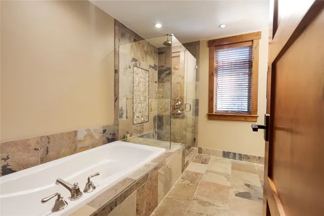 a spacious bathroom with a double vanity sink a mirror and a shower