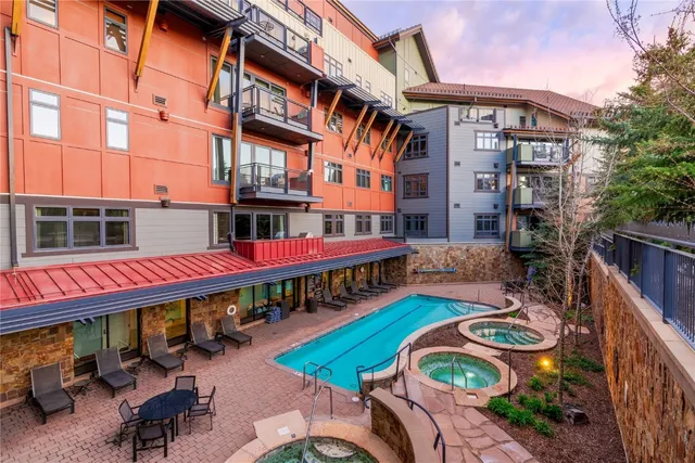 a living room with furniture fireplace and a large window