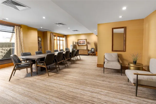 a view of a house with a yard and sitting area