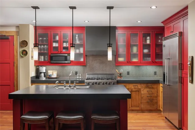 a kitchen with stainless steel appliances a sink stove and refrigerator
