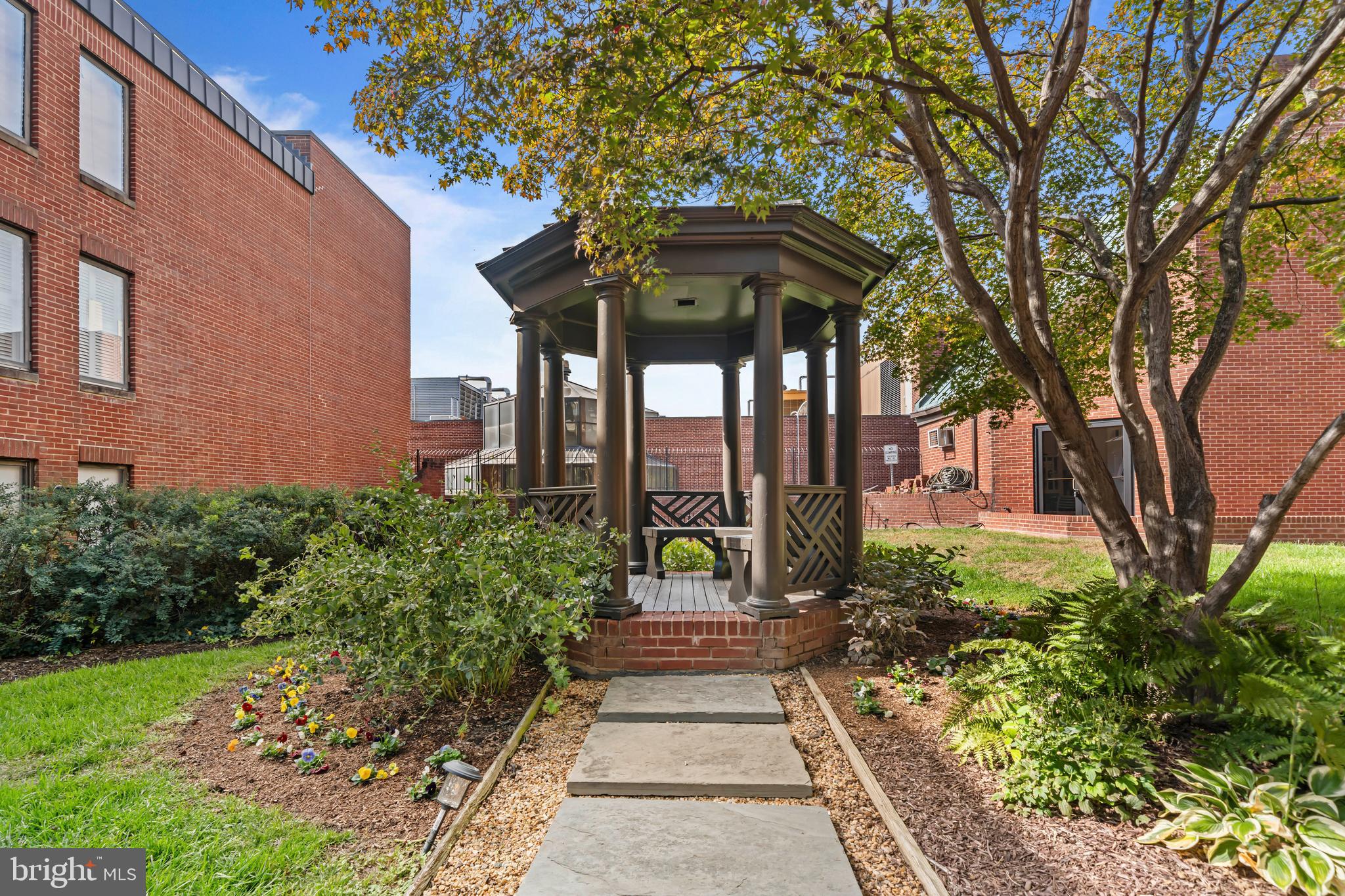3225 Grace Street Northwest, Unit 219 Washington, DC 20007 - Photo 2 of 4 a front view of a house with garden