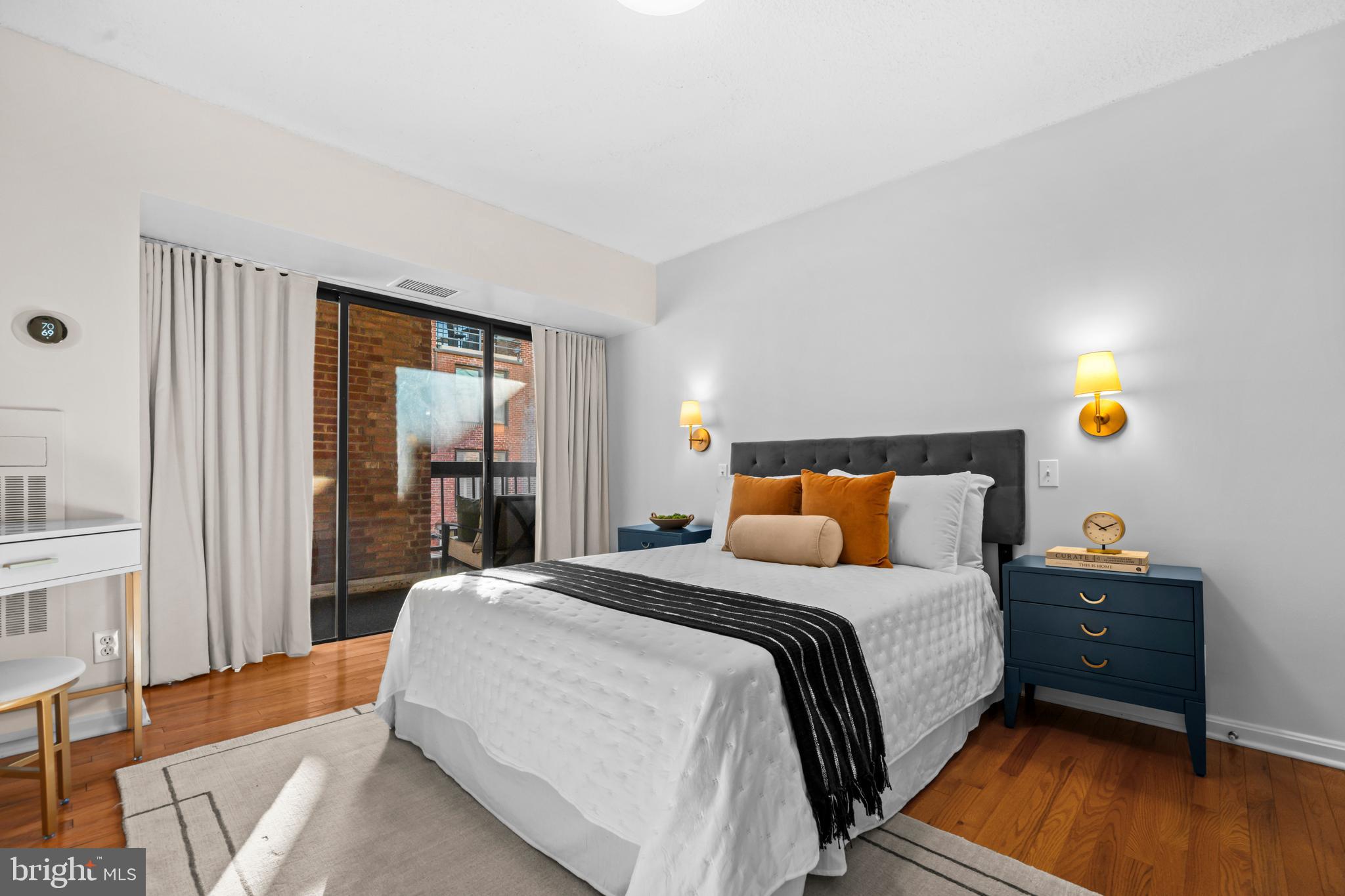 3225 Grace Street Northwest, Unit 219 Washington, DC 20007 - Photo 24 of 45 a bedroom with a bed and wooden floor