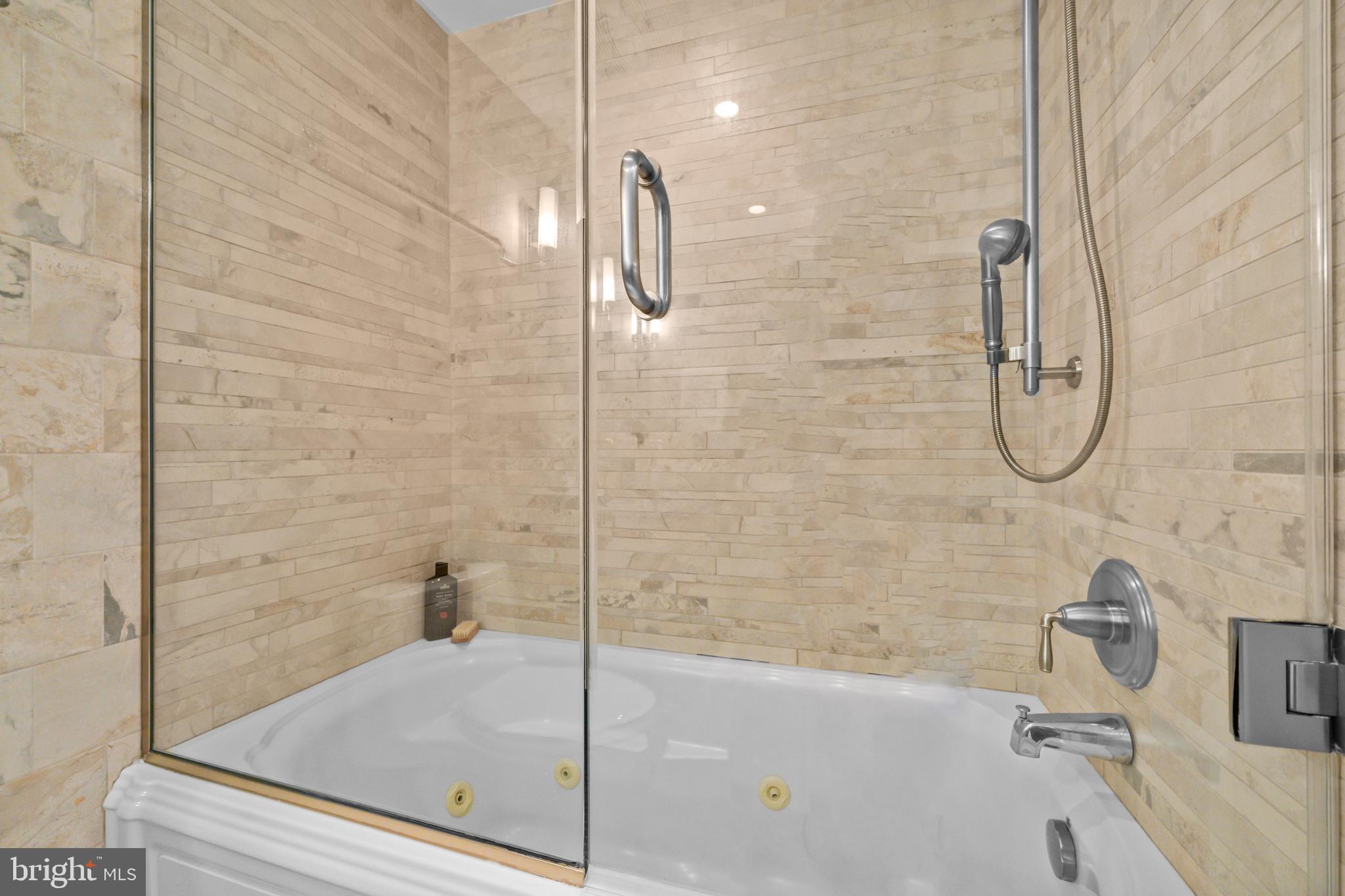 3225 Grace Street Northwest, Unit 219 Washington, DC 20007 - Photo 29 of 45 a bathroom with a bath tub