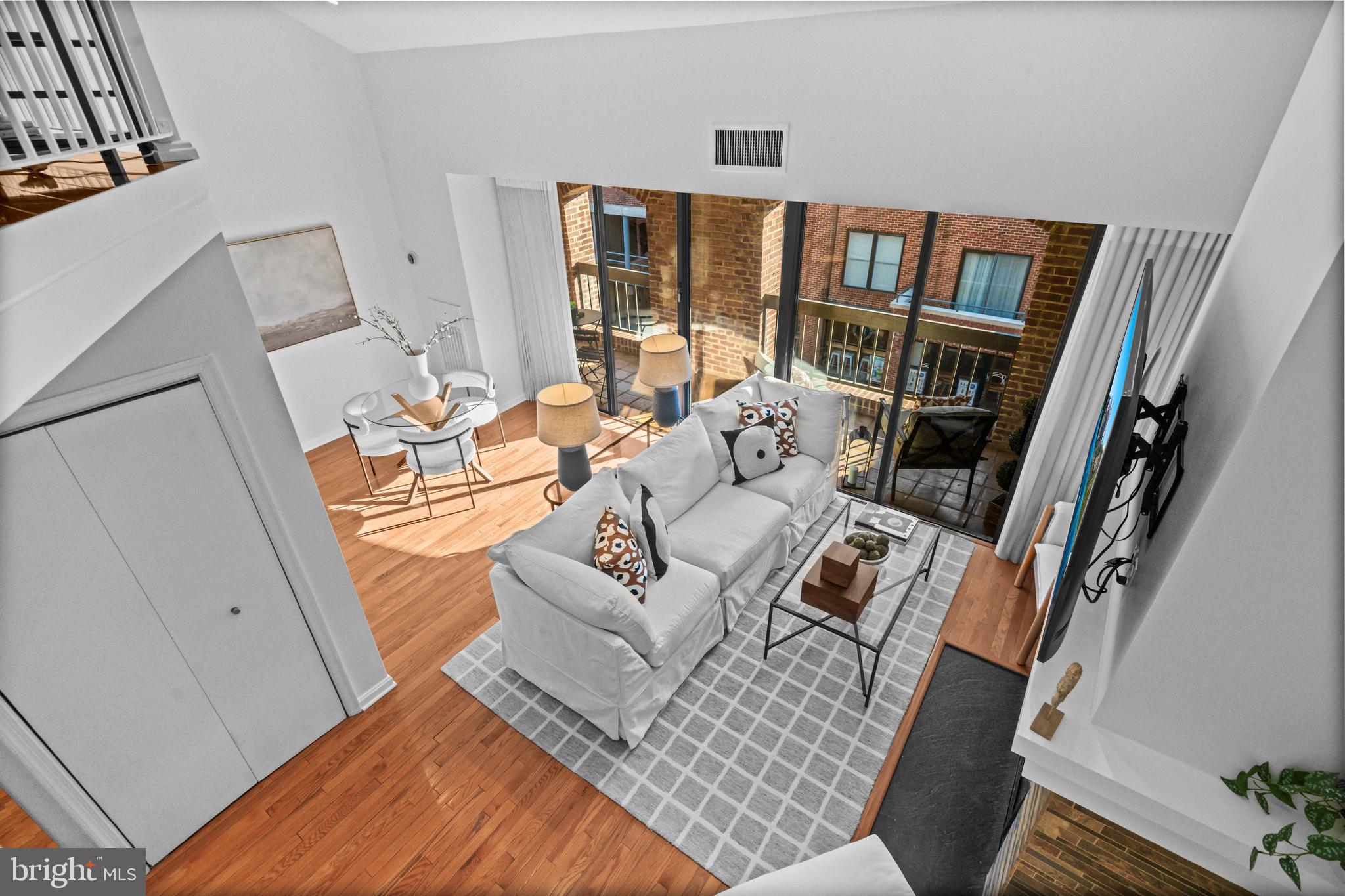 3225 Grace Street Northwest, Unit 219 Washington, DC 20007 - Photo 8 of 45 a living room with furniture and a floor to ceiling window