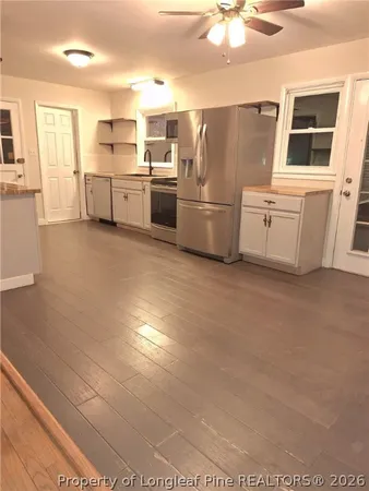 a kitchen with refrigerator and stove