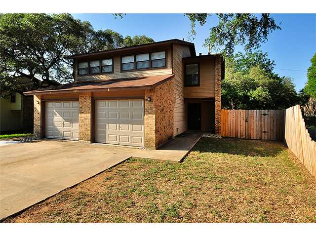 6031 Old Fredericksburg Road, Unit B Austin, TX 78749 - Photo 1 of 1 a front view of a house with a yard and garage