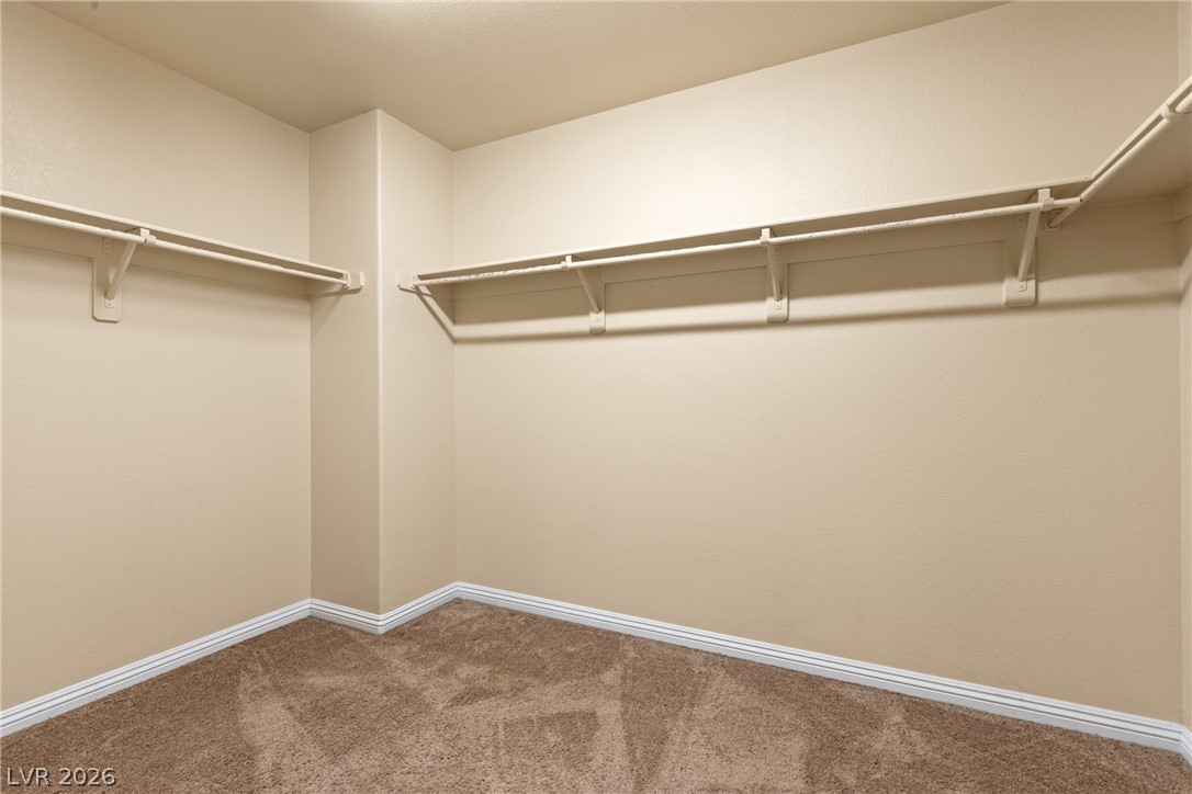 8934 Deep Ridge Court Las Vegas, NV 89178 - Photo 27 of 47 Ample hanging space and durable carpet flooring define this practical closet.