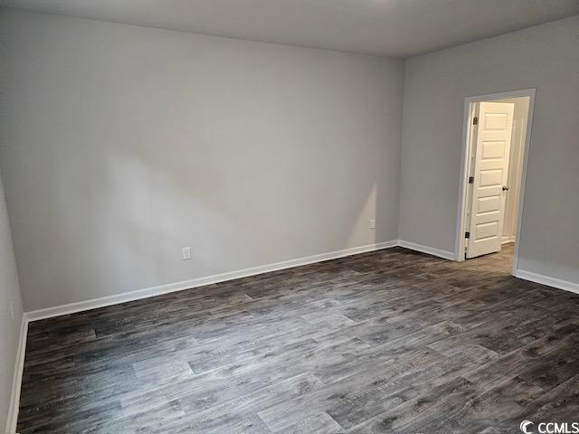 454 Ladyfish Loop Northwest Sunset Beach, NC 28468 - Photo 4 of 17 Spare room with dark wood-style floors and baseboa