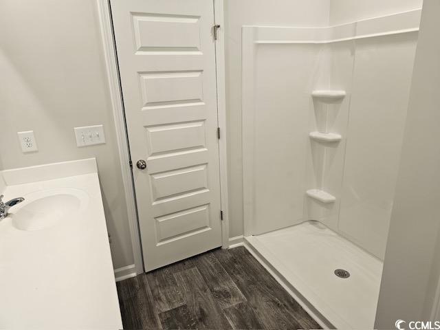 454 Ladyfish Loop Northwest Sunset Beach, NC 28468 - Photo 6 of 17 Bathroom with vanity, wood finished floors, and wa