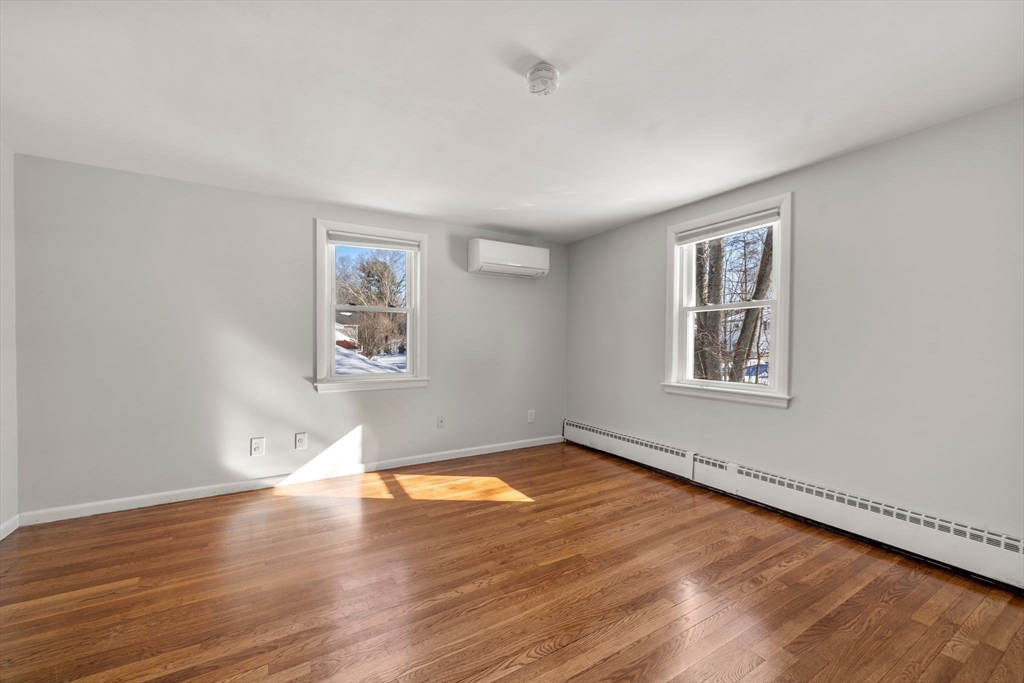 356 Central Street Framingham, MA 01701 - Photo 13 of 25 a view of a big room with wooden floor and windows