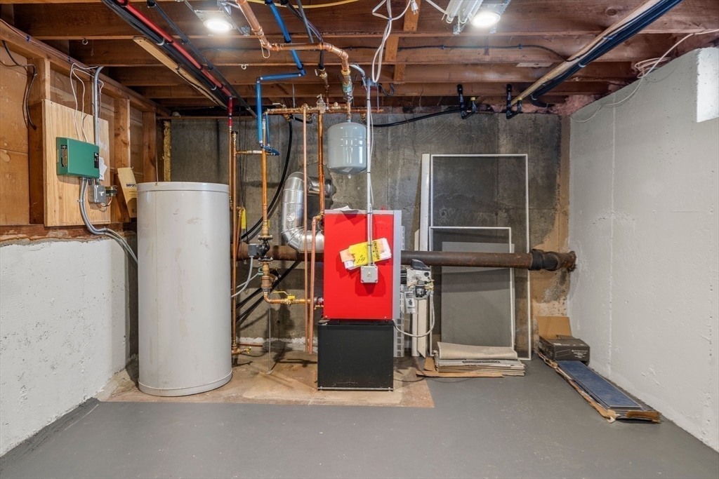 356 Central Street Framingham, MA 01701 - Photo 16 of 25 a room with water heater and storage