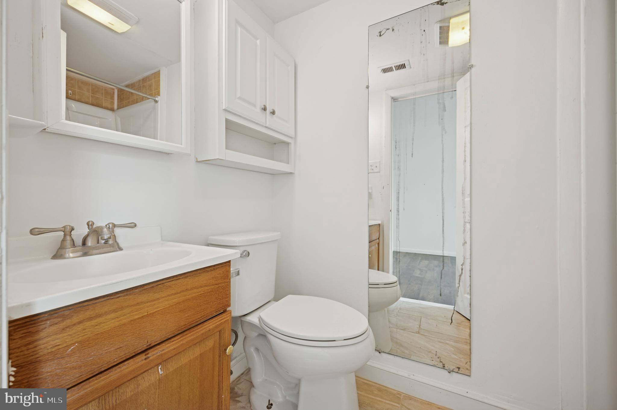 710 Willow Street, Unit B Lansdale, PA 19446 - Photo 11 of 25 a bathroom with a sink toilet and vanity