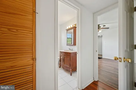 a view of a hallway with wooden floor and staircase